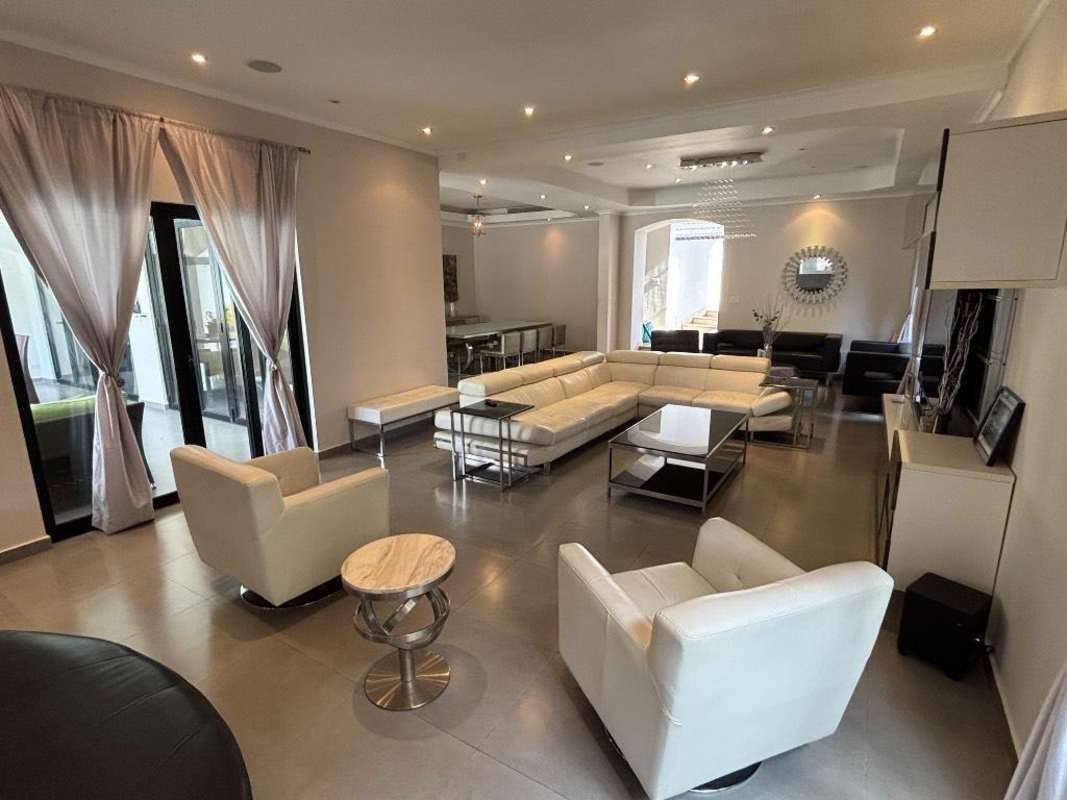 Crisp designer living room with ample seating elegant details PH Magnolia Costa del Este