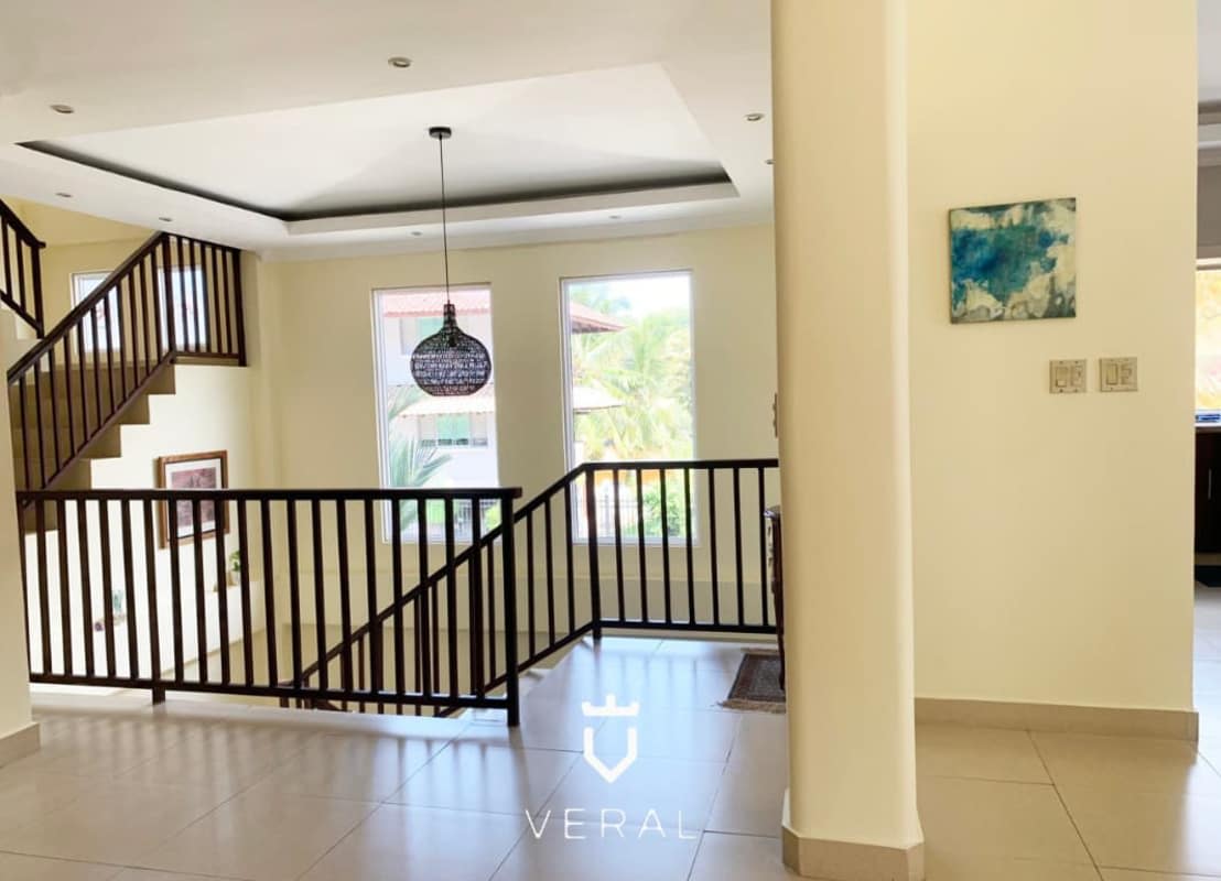 Open living area with large windows and marble floors in gated Albrook community Panama