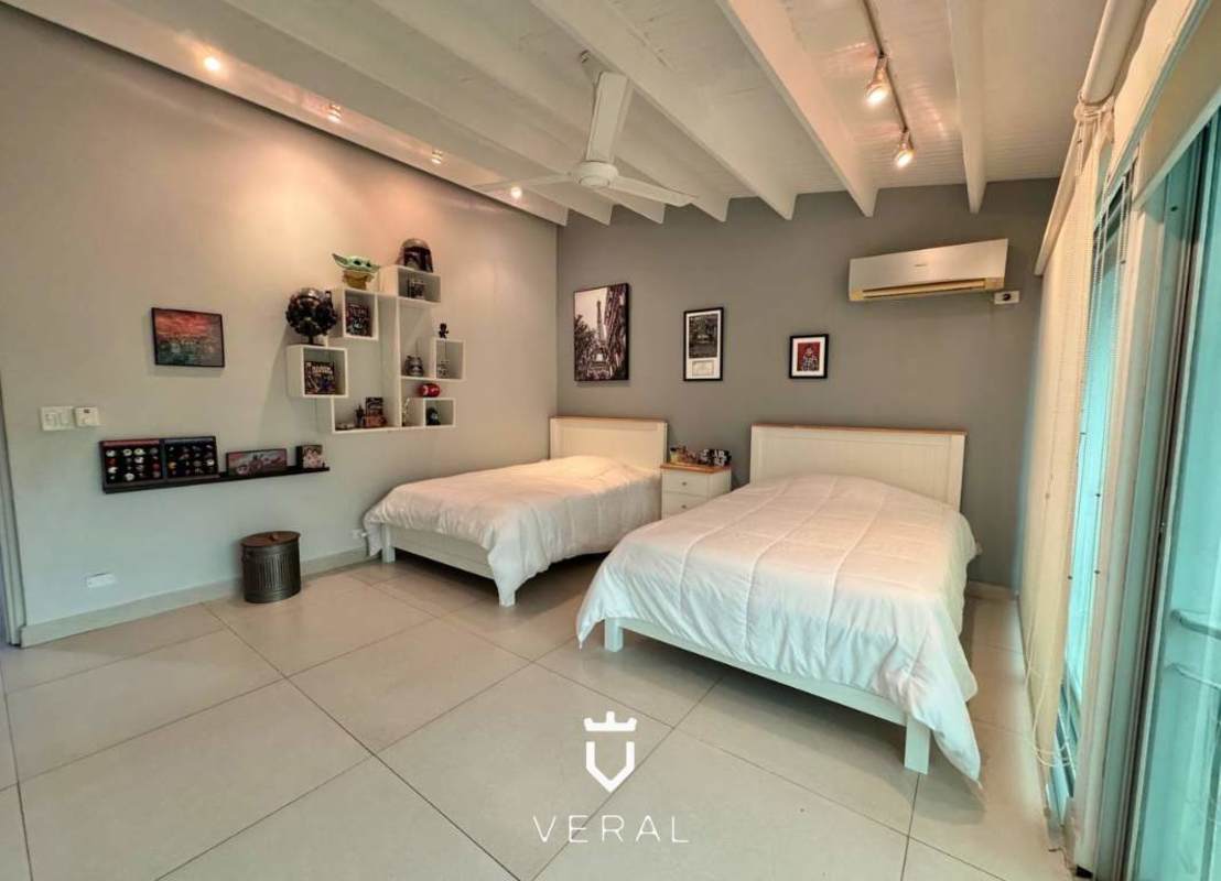 Large master bedroom with private bathroom and walk-in closet at house in La Alameda Betania Panama
