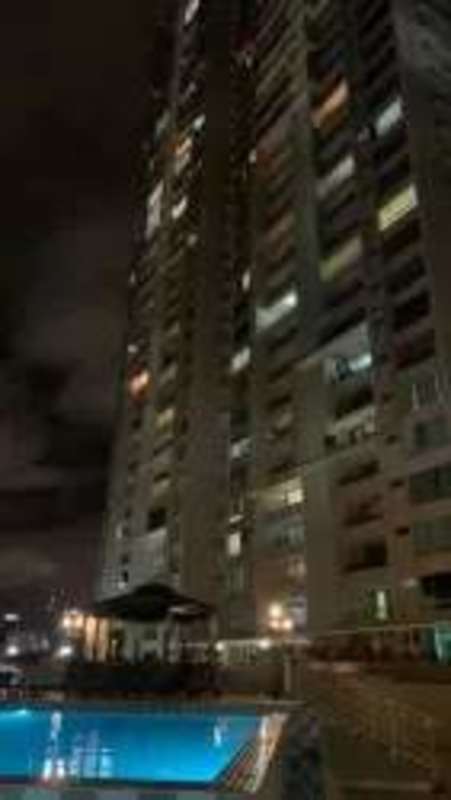 Night-lit PH Terrasol tower with illuminated swimming pool and gazebo in San Francisco Panama
