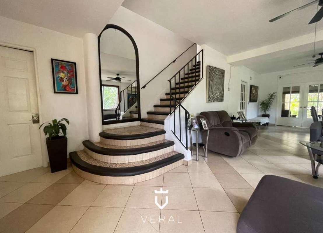 Covered patio terrace with outdoor sitting area in garden home for sale Panama City