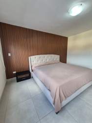 Bright master bedroom furnished with closet and AC unit in PH Midrise Panama Pacifico