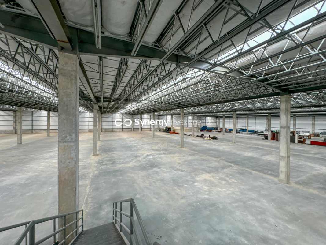 Warehouse mezzanine level for office or storage with metal railings and concrete floors