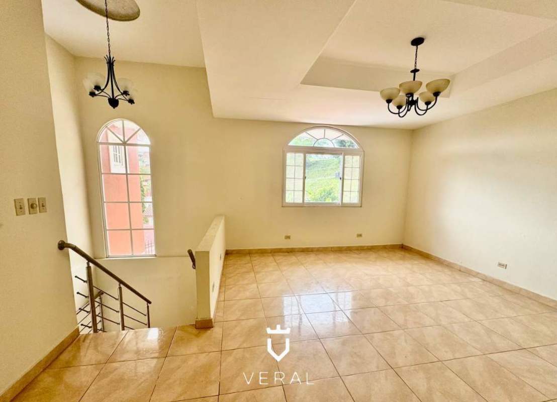 Bright living room with marble floors, chandeliers and large arched windows in Villa del Lago Las Cumbres Panama