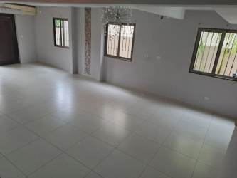 Large open living room with built-in bar, stone accent wall in Howard Panama