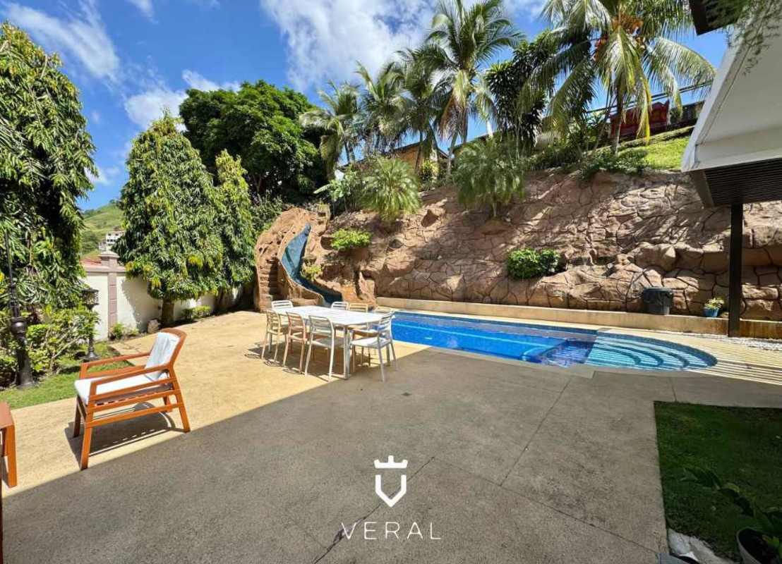 Covered terrace with outdoor seating, BBQ area, and ceiling fan in Fuente del Fresno Panama