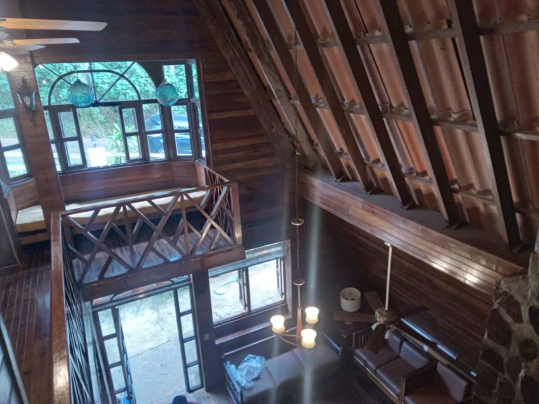 Exterior A-frame rooftop with balconies surrounded by pine forest cabin Cerro Azul Panama