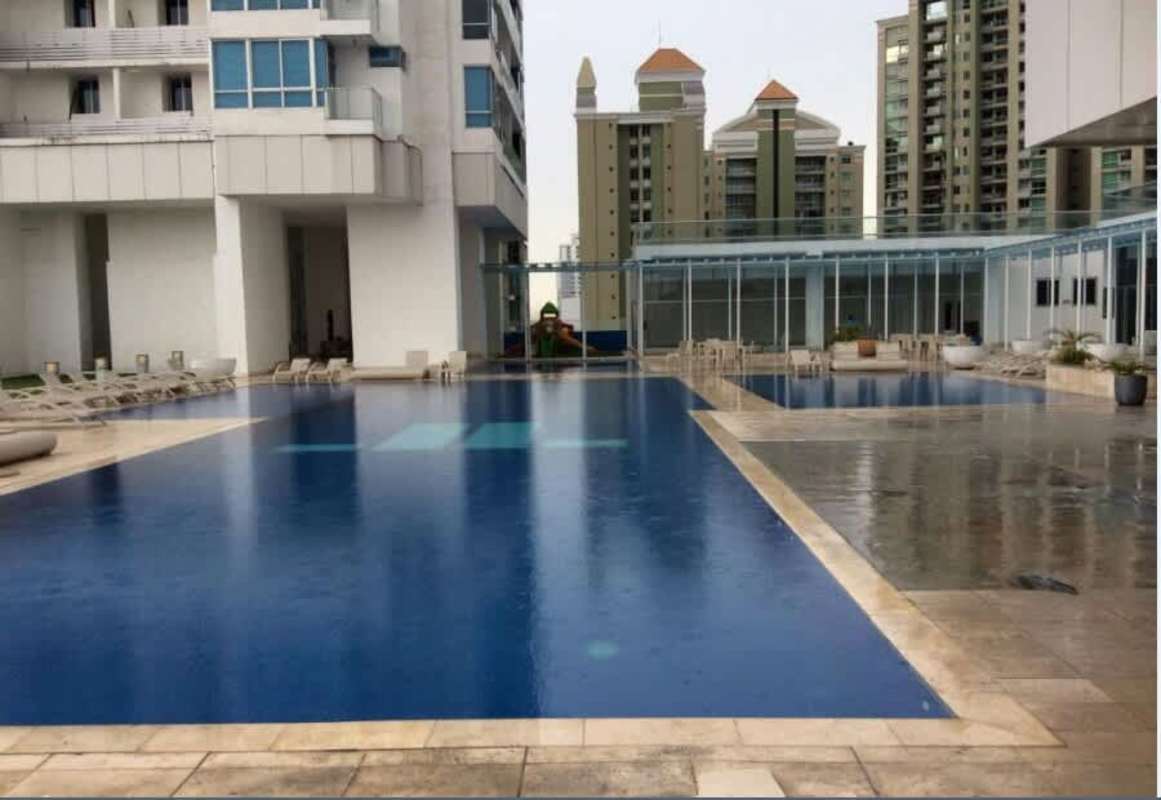 Outdoor pool with lounge chairs play area PH Top Tower Costa del Este Panama