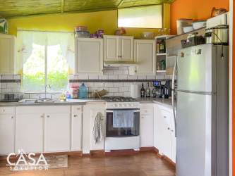 Kitchen with wood cabinets, appliances, vibrant decor in Boquete mountain home