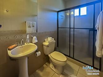 Spacious master bedroom with large window overlooking mountains at Los Molinos Boquete Panama