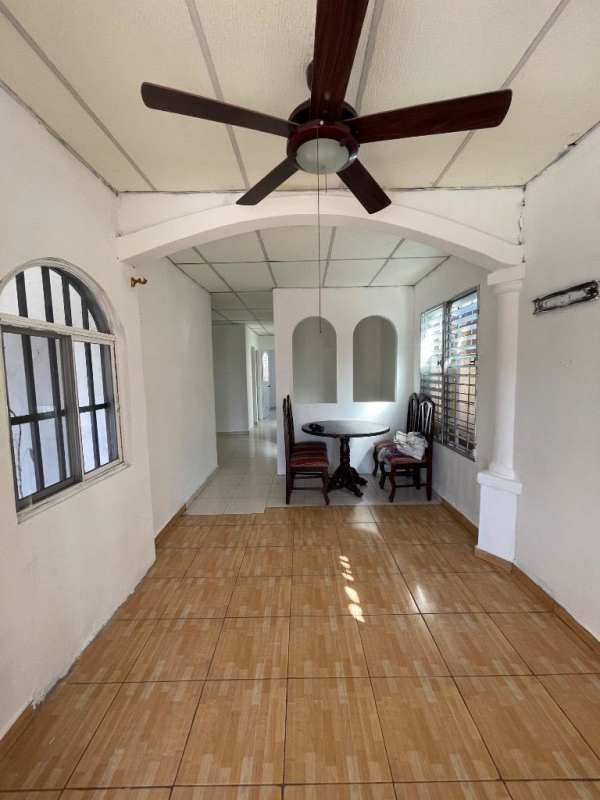 Dining nook with ceiling fan, archways and tiled floor in Panama City house