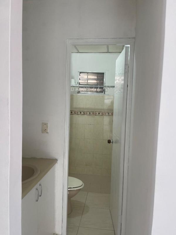 Traditional bathroom with beige ceramic tiles, window and shower in Don Bosco