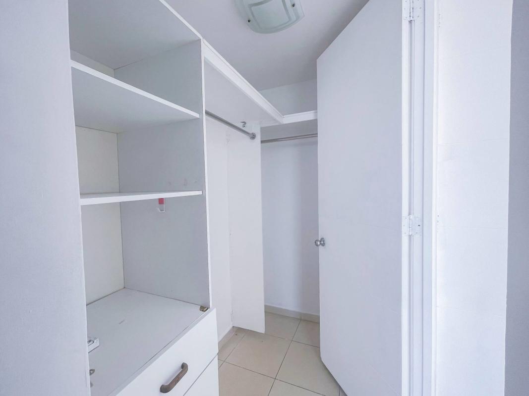 Bright living room with sliding doors to balcony, large windows, tiled floors at PH Terrasol Panama