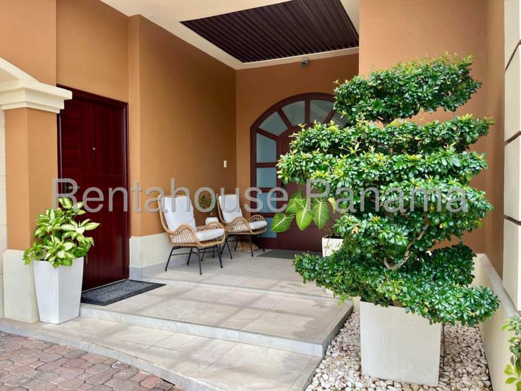 Mediterranean facade with tile roof, lush landscaping, garage at Sunset Coast Costa Sur Panama