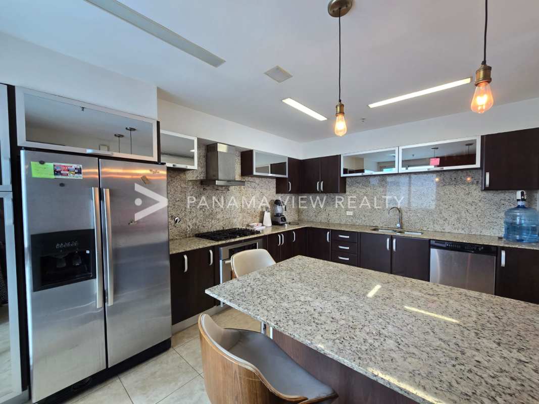 Spacious enclosed kitchen with granite countertops and stainless appliances in PH Titanium Panama