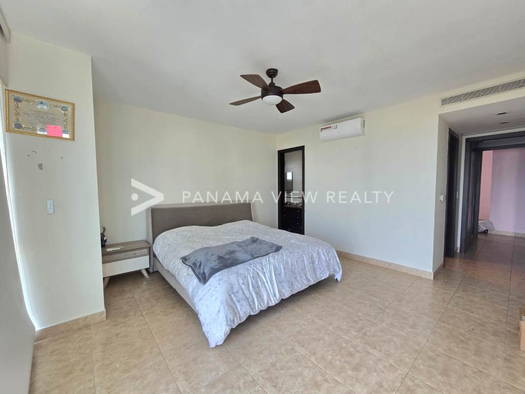 Spacious master bedroom with large windows, partial sea view and ensuite at Titanium Panama