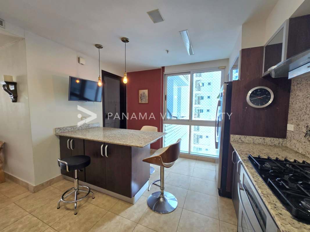 Dining space opening onto balcony with skyline views in PH Titanium Costa del Este Panama