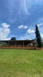 Covered patio overlooking large landscaped garden Villa Rosario Capira Panama