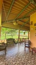 Traditional covered terrace with columns and tile floors of country house Villa Rosario Capira Panama