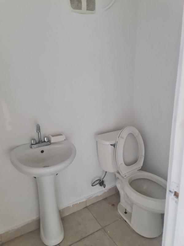 Small bathroom with pedestal sink and toilet in commercial property Parque Lefevre Panama