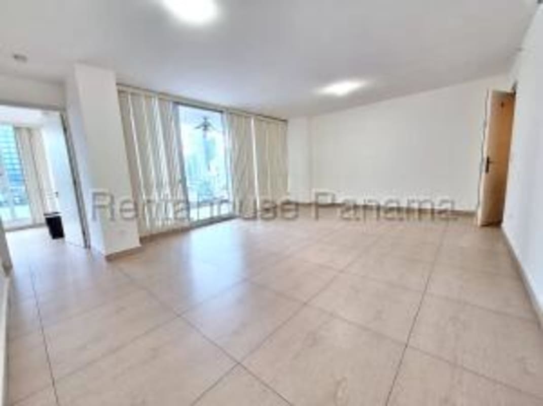 Spacious living area with panoramic windows and partial ocean view in Bella Vista Tower Panama City