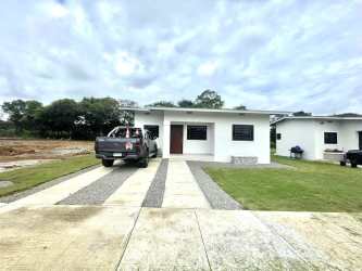 Bright entryway with open red front door and large window at Los Algarrobos house Dolega Panama
