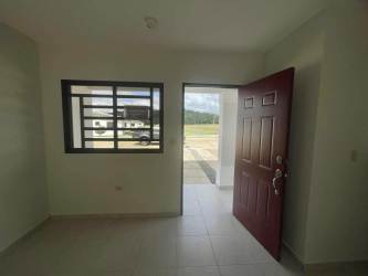 Minimalist kitchen with granite countertops, dark cabinets at Los Algarrobos rental house Panama