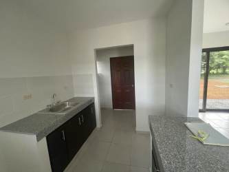 Granite countertop minimalist kitchen with white walls Los Algarrobos rental home Chiriquí