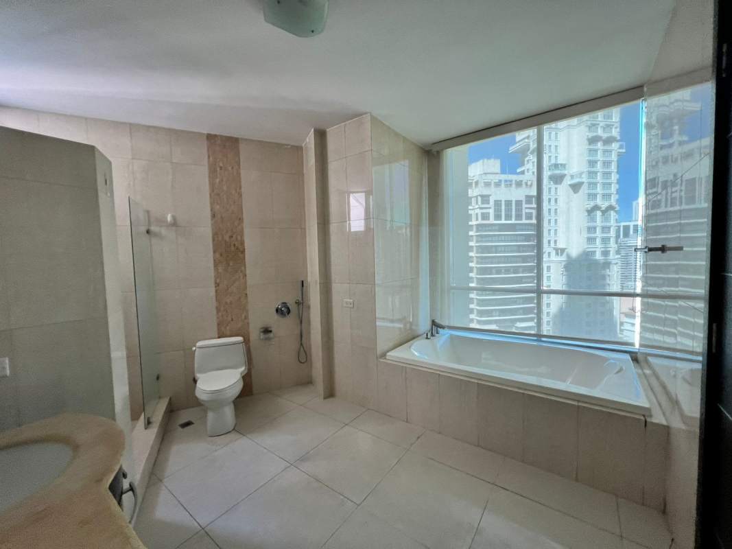 Luxury bathroom with bathtub, glass shower and double vanity at BICSA Tower Panama apartment