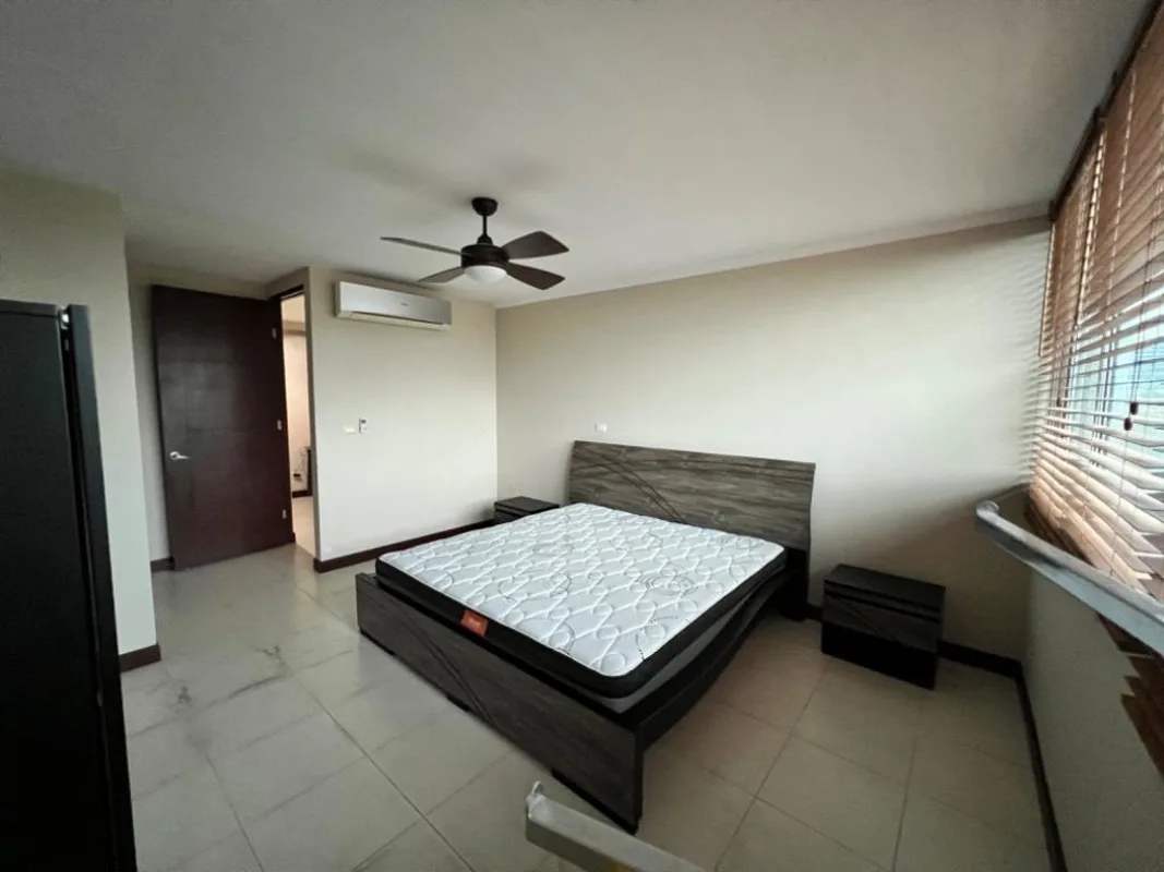 Spacious kitchen with granite counters, wooden cabinets, appliances in PH Titanium Tower Costa del Este Panama