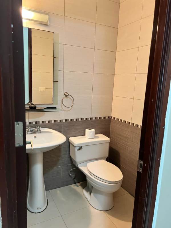 Bedroom with large window, ocean views, en suite bath in PH Titanium Tower Costa del Este