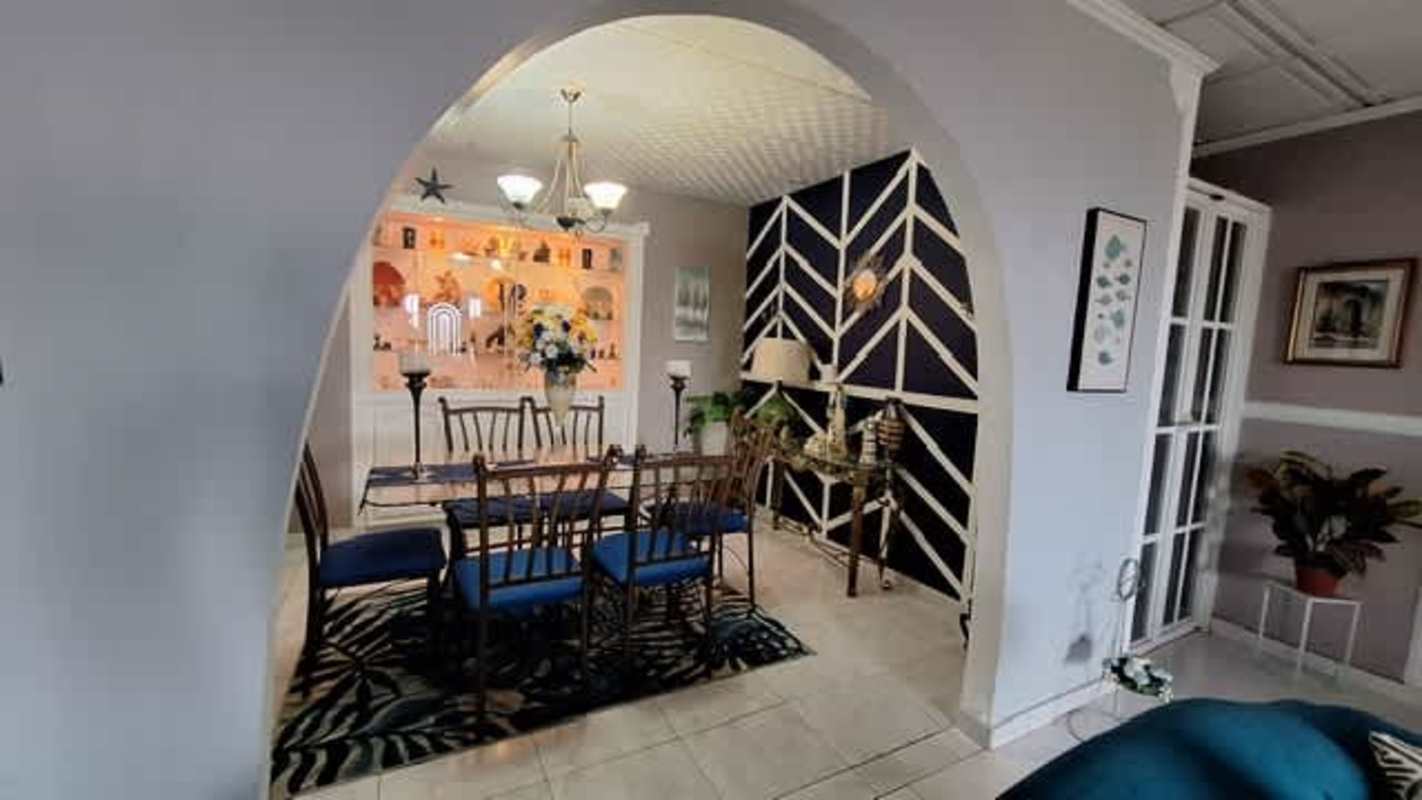 Modern dining room with blue chevron wall and chandelier San Antonio Panama