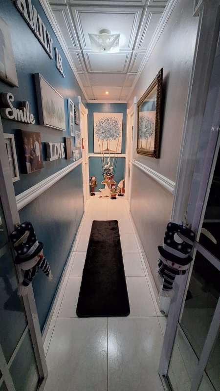 Hallway with family wall art and tile floor San Antonio Panama