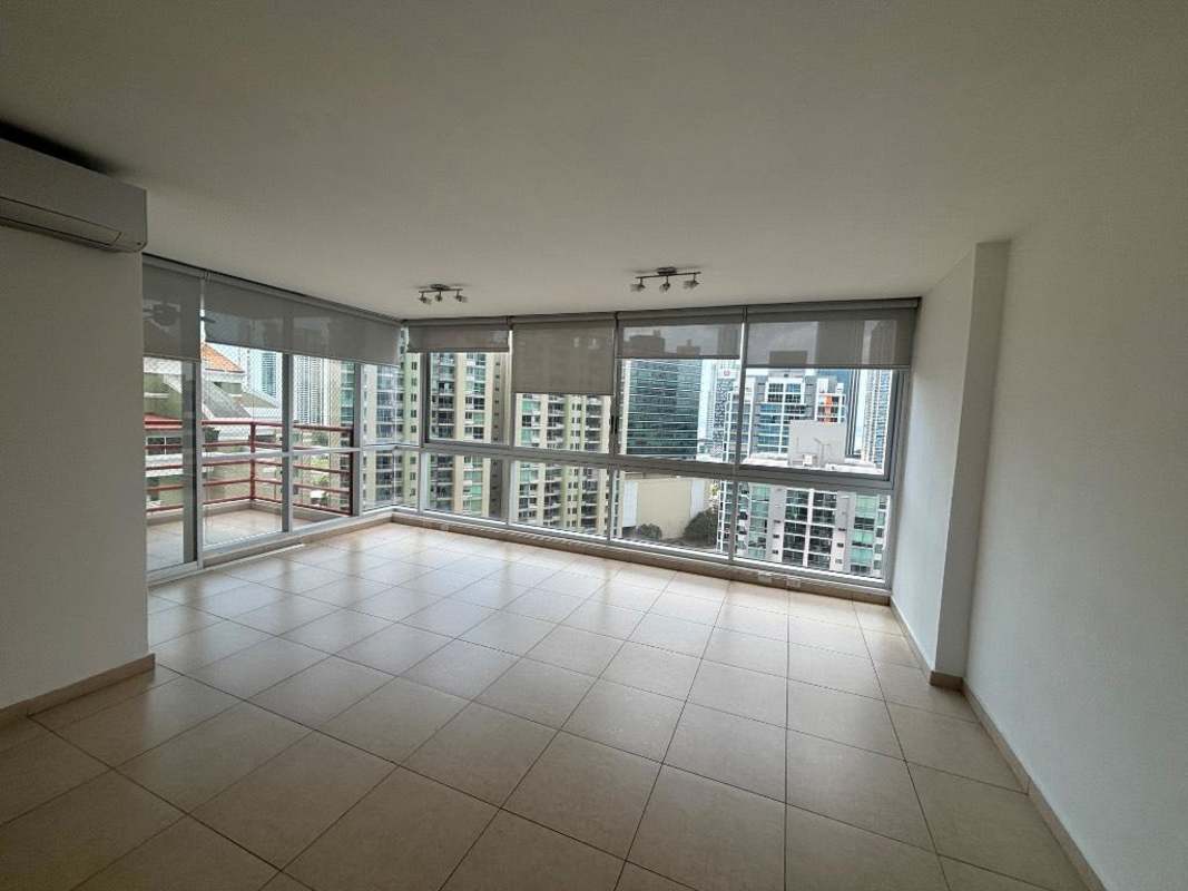 Bright open-plan living room with balcony access and city views at PH Costa View Costa del Este