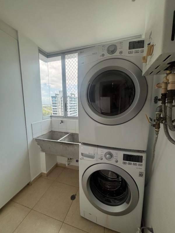Functional laundry room with washer dryer hookups, sink and window in Costa del Este apartment