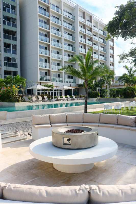 Luxury common areas with pool, palm trees, outdoor lounge at Surfside Panama
