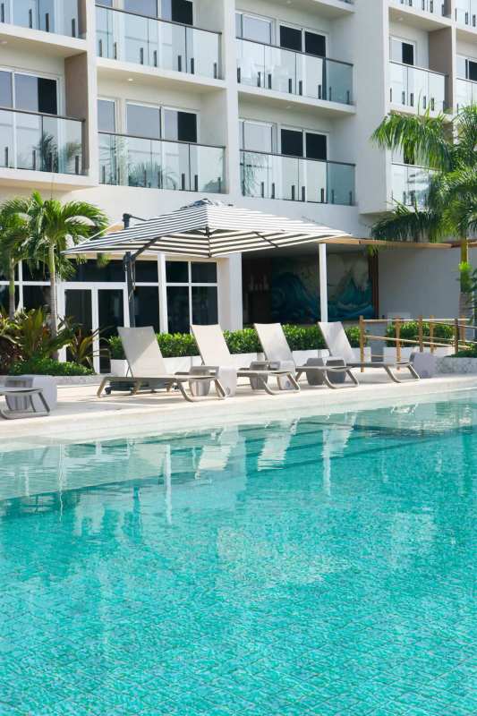 Bright bedroom with oceanfront view floor to ceiling windows Playa Caracol