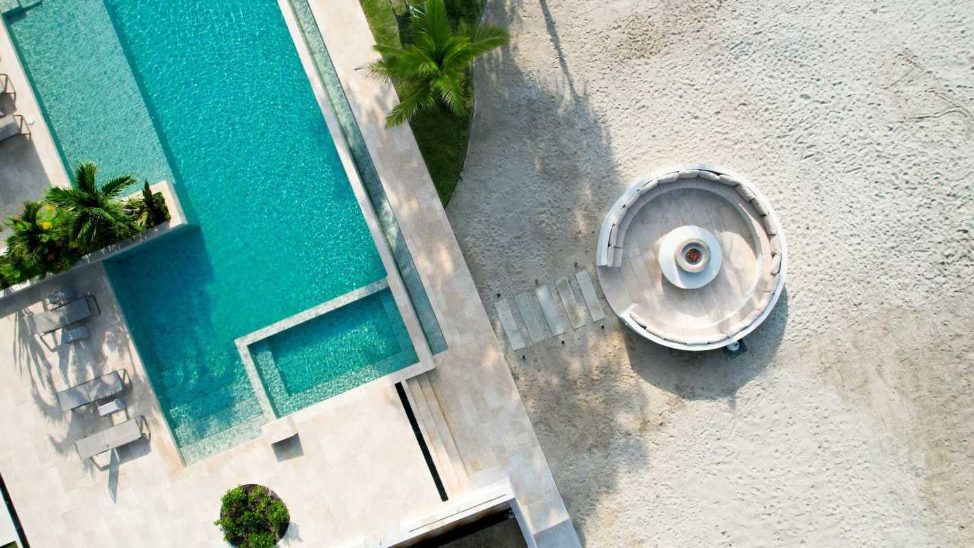 Infinity pool with palm trees and beachfront towers Surfside Panama