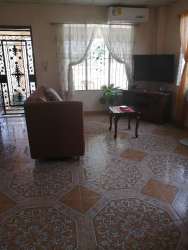 Kitchen with wooden cabinetry, stove, refrigerator, microwave, ceramic tile floor in Las Veraneras Santiago