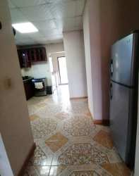 Living area with sofa, TV, large window and air conditioning in Las Veraneras Santiago Panama