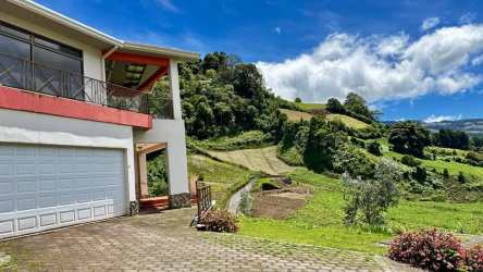 Bright kitchen with wood cabinetry and granite counters surrounded by mountain scenery