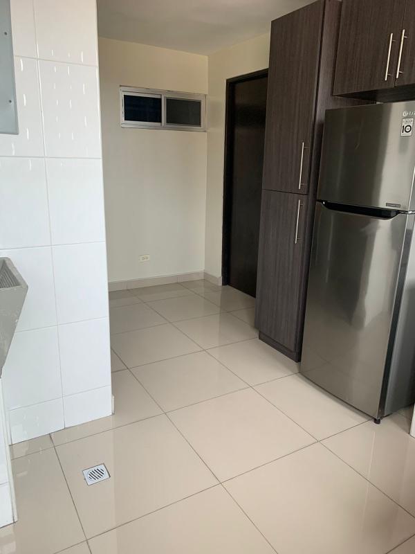 Compact kitchen with refrigerator, granite counters, gas stove in PH Enrique Grenzier Panama
