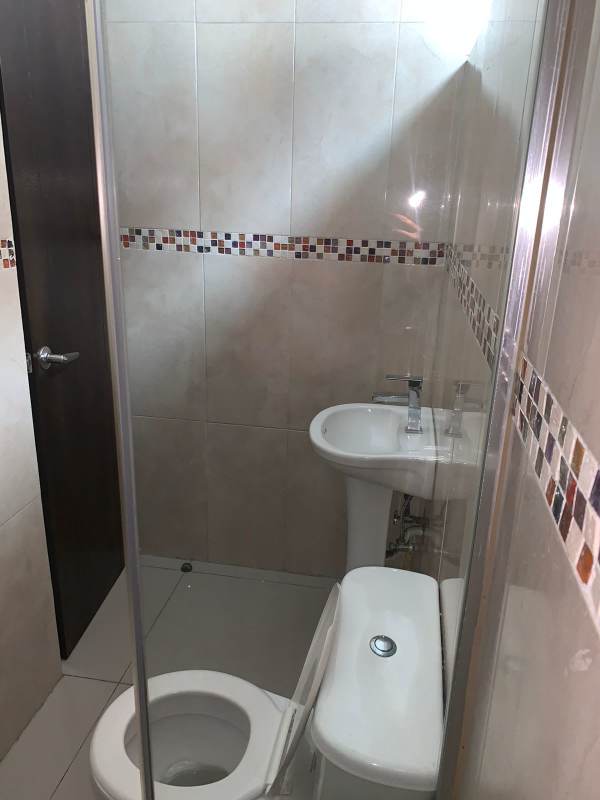 Contemporary bathroom with mosaic tile, glass shower, white fixtures El Cangrejo Panama