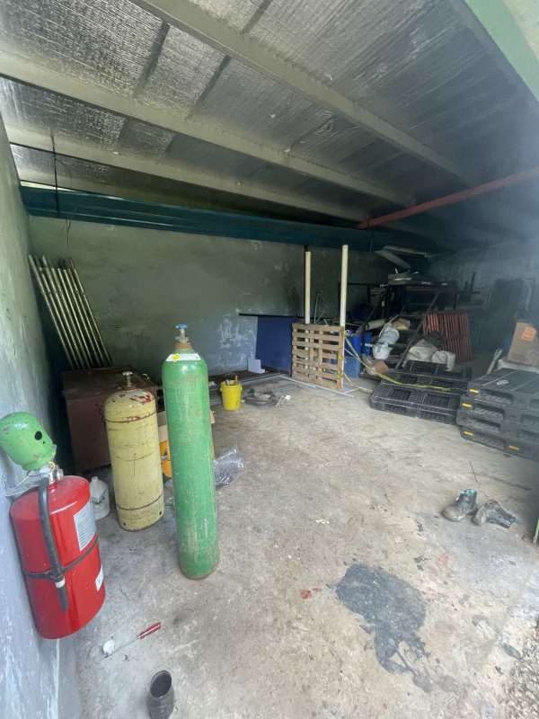 Industrial warehouse space with metal roof storage room gas tanks at Llano Bonito Panama City