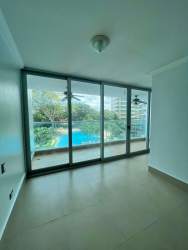 Living and dining area with ocean views in Malibu Tower beachfront apartment Panama