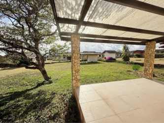 Exterior view single story Mediterranean home with mountain backdrop at Los Molinos Boquete Panama