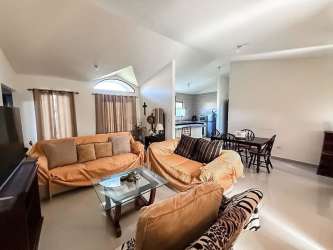 Bedroom with two beds floral bedding curtained window stylish decor in rental Los Molinos Boquete