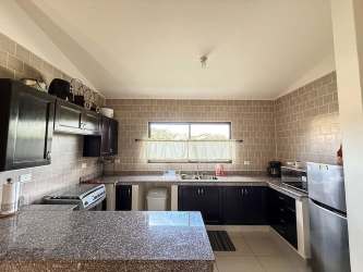 Rustic Mediterranean house exterior with covered porch landscaped yard at Los Molinos Boquete