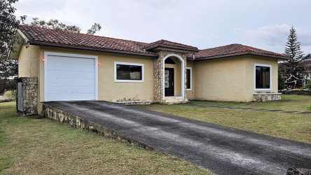 Contemporary bright living and dining area with large windows and neutral decor in Los Molinos Boquete rental home