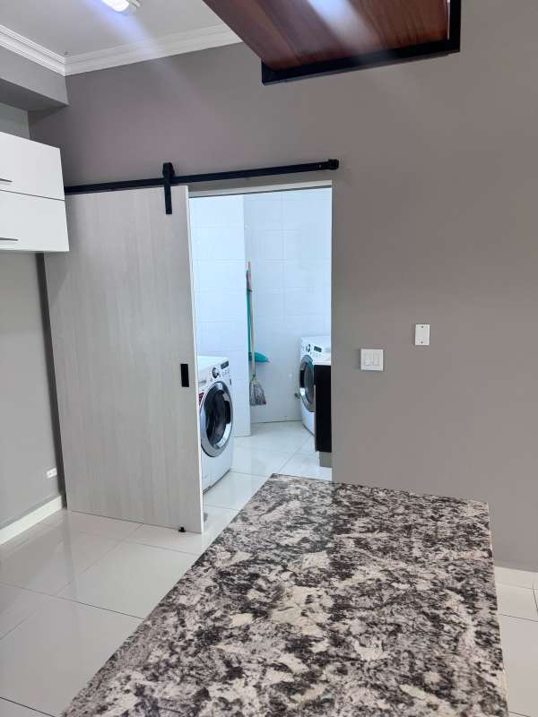 Large bedroom with ocean views, panoramic window, chandelier, tiled floor in Nautica Tower Panama